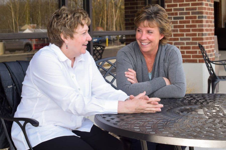 100 Women Who Care conversation at a table
