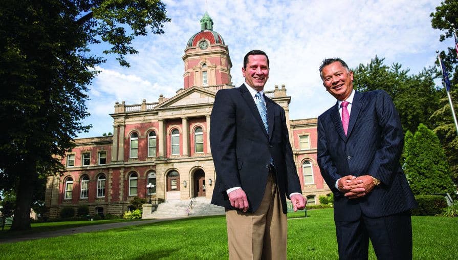 Pete McCown and Dzung Nguyen standing in front of the County Courthouse